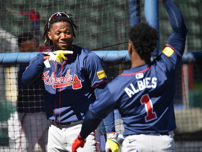 Atlanta Braves players Ronald Acuna, Jr. (#13), left, and Ozzie Albies (#1) joke around during batting practice Tuesday, Feb. 20, 2024 at CoolToday Park in North Port, Florida.  